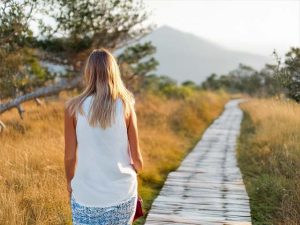 image of a woman at the starting point of walking on a pathway